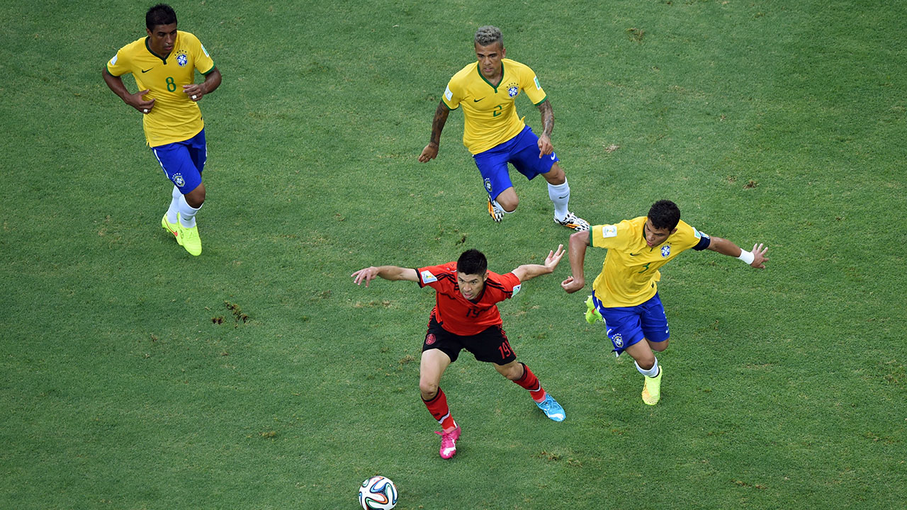 Mexico's Oribe Peralta is chased by Brazil's Paulinho, Dani Alves and Thiago Silva, from left, during the group A World Cup soccer match between Brazil and Mexico.