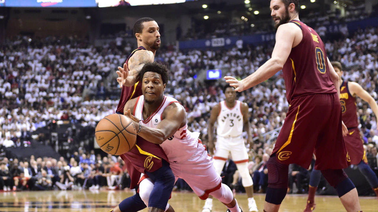 Toronto Raptors guard Kyle Lowry (7) passes around Cleveland Cavaliers guard J.R. Smith (5) in Toronto on Thursday, May 3, 2018. (Frank Gunn/CP)