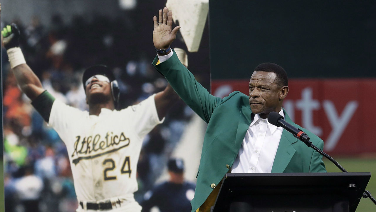 Former baseball player Rickey Henderson waves after speaking during a ceremony inducting him into the Oakland Athletics' Hall of Fame before a baseball game between the Athletics and the New York Yankees in Oakland, Calif., Wednesday, Sept. 5, 2018. (AP Photo/Jeff Chiu)